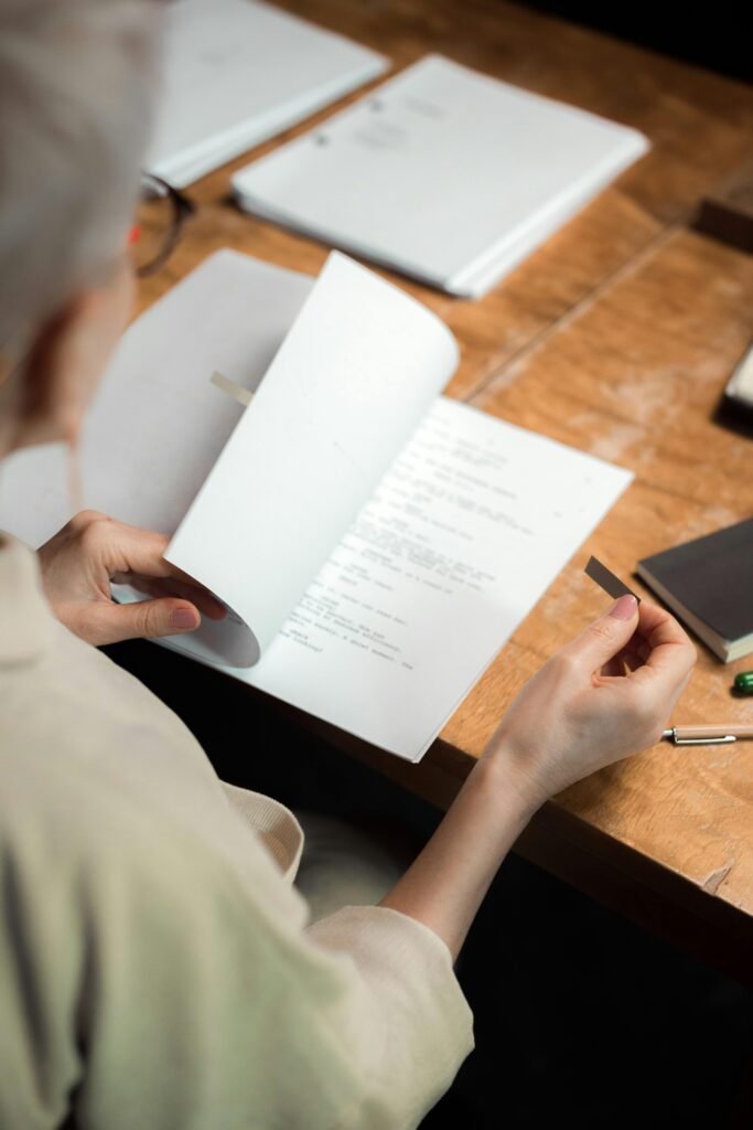 Close-up of a person reading a script, focusing on details.